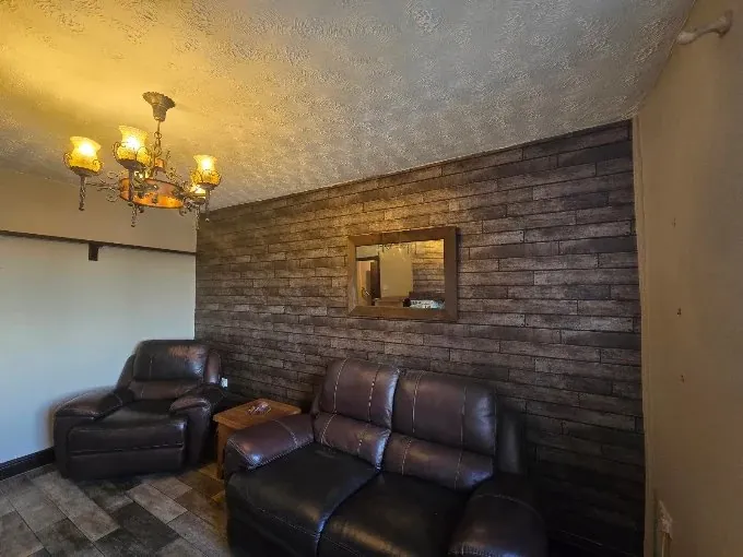 Living room with a brick-effect wallpaper feature wall