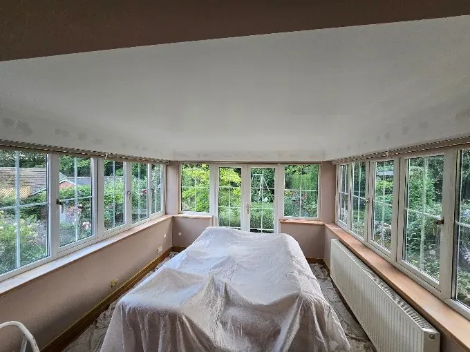 Garden room with all the furniture sheeted before work starts