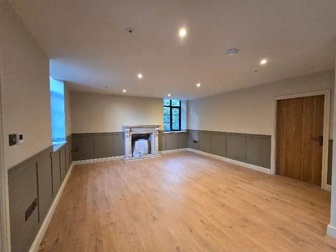 Large room with wall panelling painted mushroom