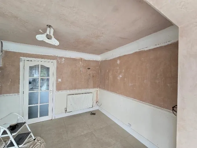 A room stripped back to bare plaster, ready for decorating