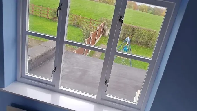 White painted window frames in a blue room